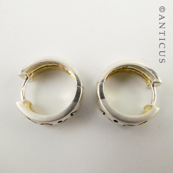 Small Silver Hoop Earrings with Abstract Design.