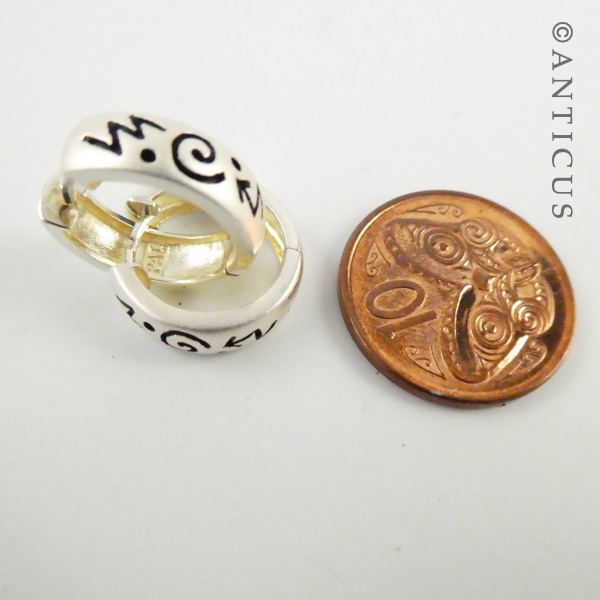 Small Silver Hoop Earrings with Abstract Design.