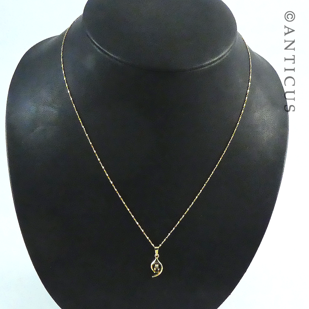 Small Garnet Pendant on Gold Chain.