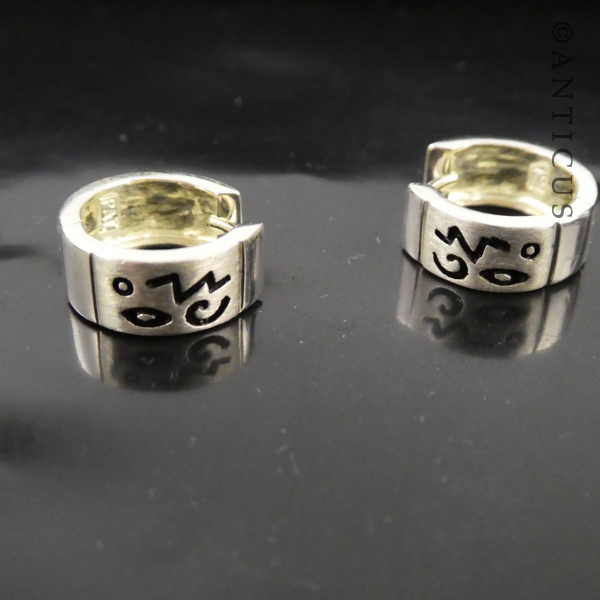 Small Silver Hoop Earrings with Abstract Design.