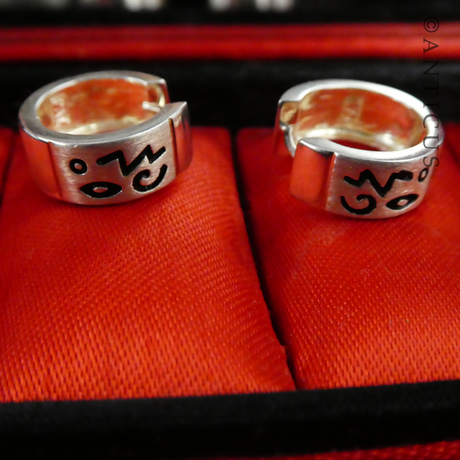 Small Silver Hoop Earrings with Abstract Design.