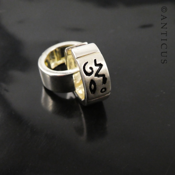Small Silver Hoop Earrings with Abstract Design.