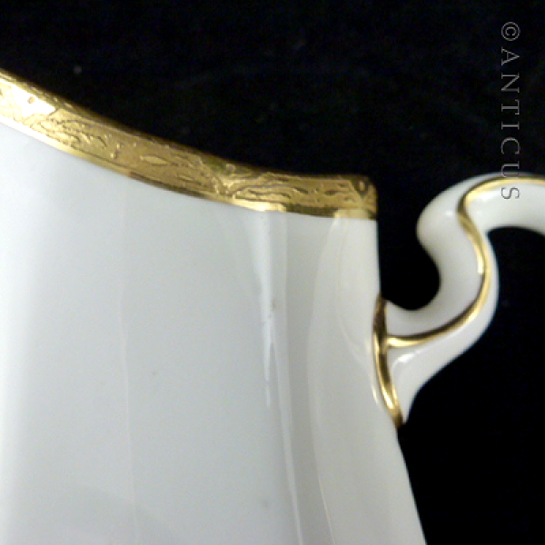 Pair of Minton Gold and White Jugs.