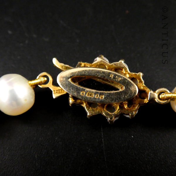 Strand of Pearls with Gold and Garnet Clasp.