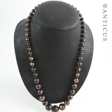 Necklace of Black, Pink, Gold Beads.