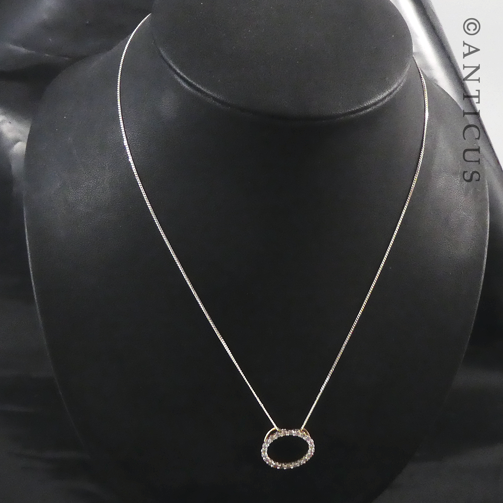 Gold and Diamond Circular Pendant on Chain.