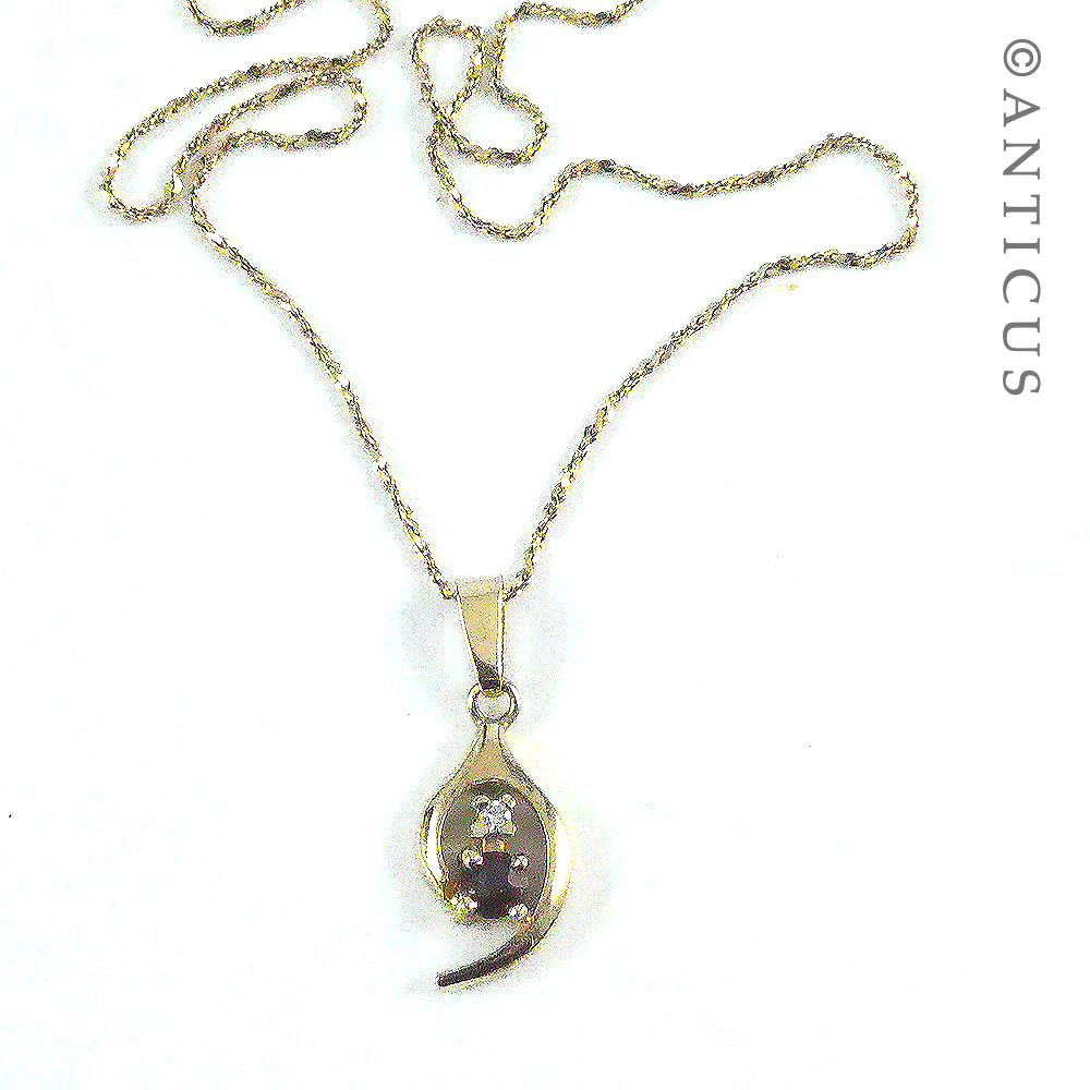 Small Garnet Pendant on Gold Chain.