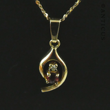 Small Garnet Pendant on Gold Chain.