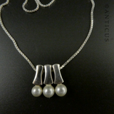 Three Pearl Pendants on Silver Chain.