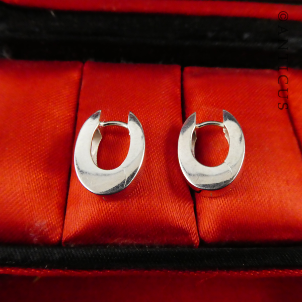 Oval Sterling Silver Huggie Earrings.