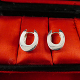 Oval Sterling Silver Huggie Earrings.