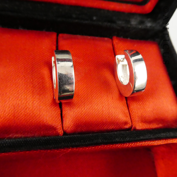 Oval Sterling Silver Huggie Earrings.