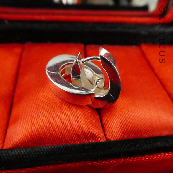 Oval Sterling Silver Huggie Earrings.