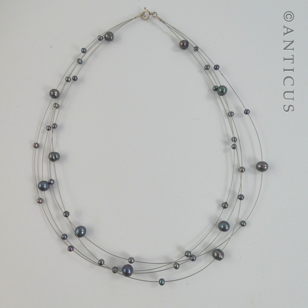 Black Pearl Four-Strand Floating Necklace.