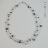 Black Pearl Four-Strand Floating Necklace.