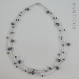 Black Pearl Four-Strand Floating Necklace.