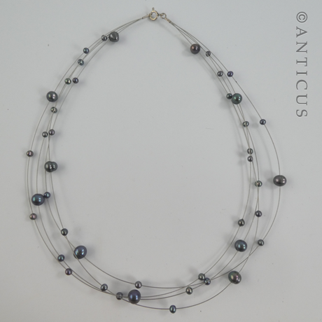Black Pearl Four-Strand Floating Necklace.