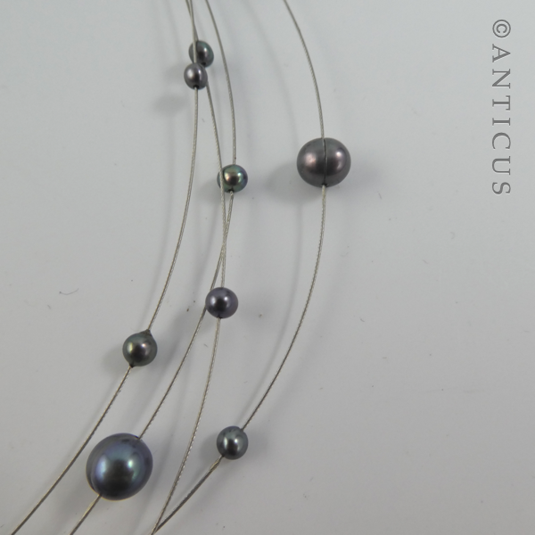 Black Pearl Four-Strand Floating Necklace.