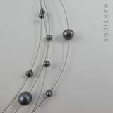 Black Pearl Four-Strand Floating Necklace.