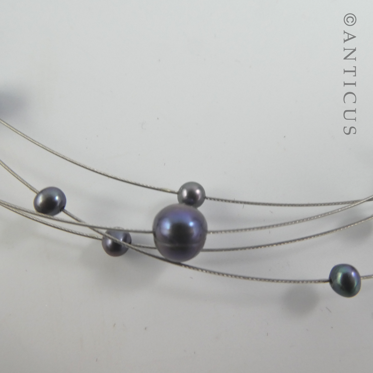 Black Pearl Four-Strand Floating Necklace.