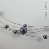 Black Pearl Four-Strand Floating Necklace.