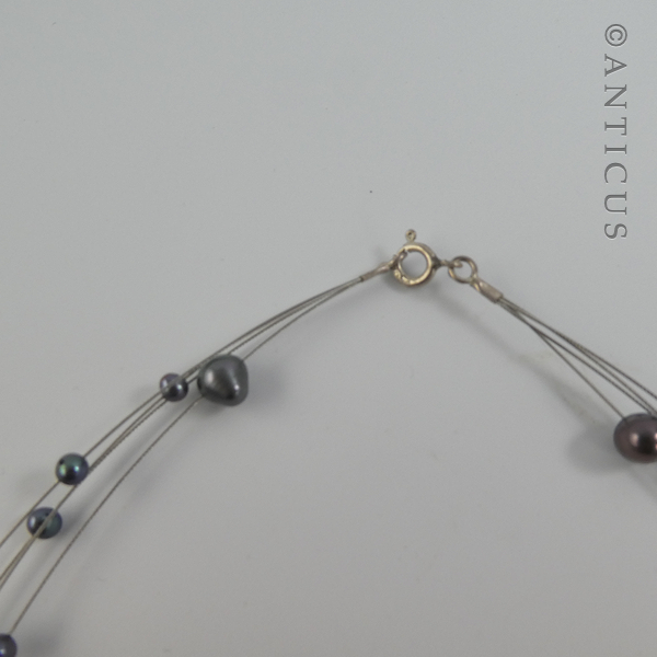 Black Pearl Four-Strand Floating Necklace.