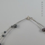 Black Pearl Four-Strand Floating Necklace.