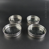 Four Sterling Silver and Cut Glass Drinks Coasters.