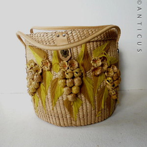 Large Round Raffia Lidded Basket with Nuts & Leaves Decoration.